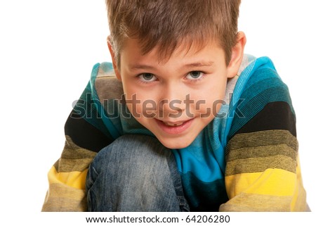 A closeup portrait of a handsome boy hugging his knee; isolated on the white background