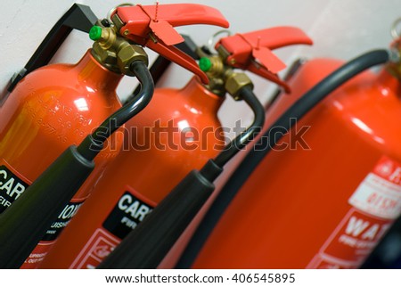 Three fire extinguishers arranged in a row
