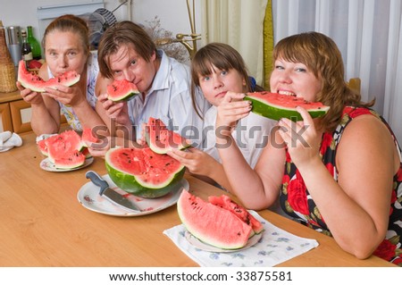 The family eats a watermelon.