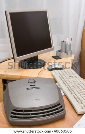 The computer and air cleaner in a school class.