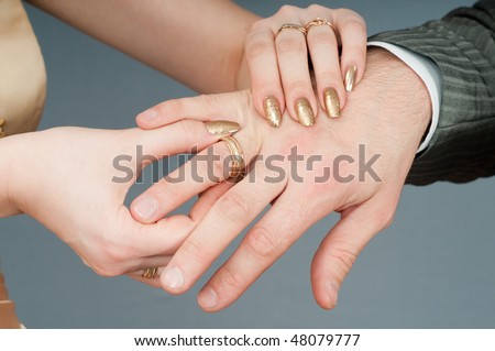 Wedding ring clothing - hands of a newly-married couple.
