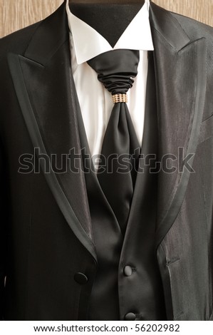 Black fashionable man\'s suit with a white shirt and a stylish tie.