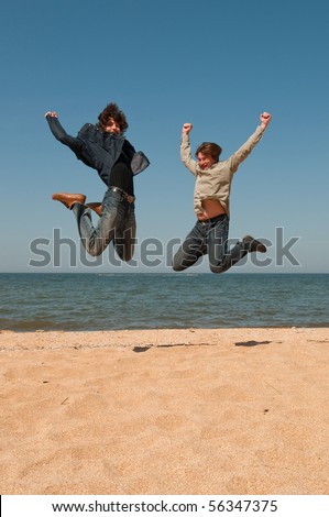 Two men jump on seacoast for pleasure - there has come day of rest!
