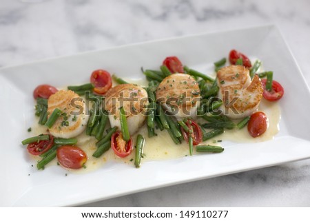 Sea Scallops with celery roots puree, haricot vert, grape tomato and chive beurre blanc.