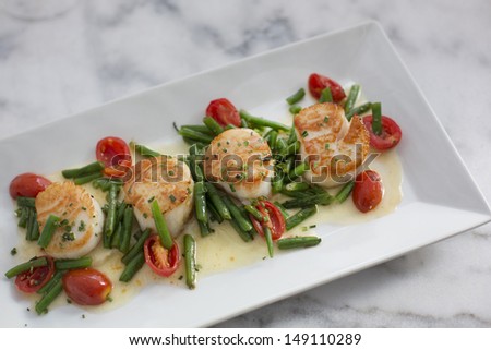 Sea Scallops with celery roots puree, haricot vert, grape tomato and chive beurre blanc.