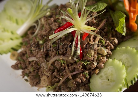 Beef larb mixed with rice powder, chili powder, onion and fresh herbs