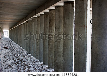 empty corridor of concrete columns in the city beach