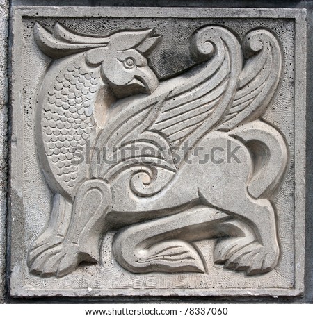 old bas-relief of fairytale fantasy winged lion on the wall