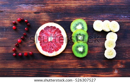 new year 2017 of fruit and berries on wooden background
