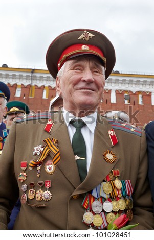 MOSCOW - MAY 9: Unidentified smiling World War II veteran on Victory Day celebration on Red Square, May 9, 2011, Moscow, Russia. Veteran is awarded with numerous of military orders and medals.