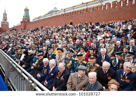MOSCOW - MAY 9: World War II veterans sit on the podium near the Kremlin Wall and watch the parade on Victory Day celebration on Red Square, May 9, 2011, Moscow, Russia.