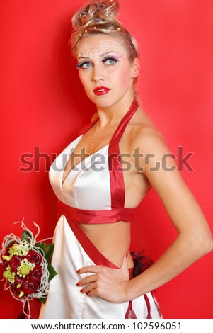 beautiful young bride wearing in white dress with red ribbons on red background