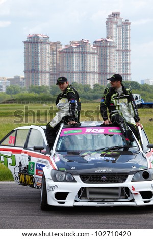 MOSCOW - JUNE 11: G.Hachatryan and G.Stepanyan sit on the car roof at 3-d tour in summer cup of Megafon mitjet race at Moscow racetrack MegaFon Tushino Ring, June 11, 2011, Moscow, Russia.
