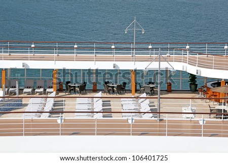 top floor of ship with deck chairs  bar