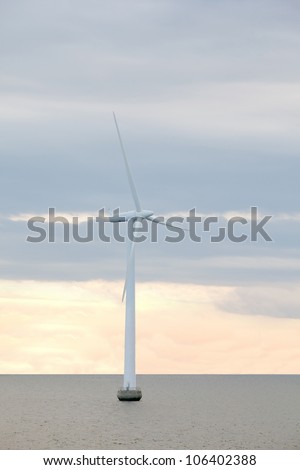 windmill stands in middle of sea