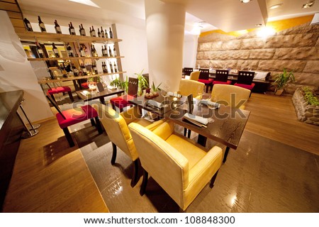 Hall with leather chairs near bar in sushi restaurant