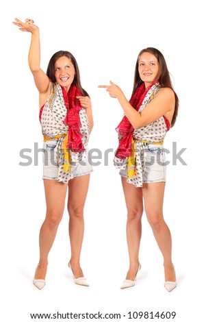 Two same women in studio on white background. First woman dances and second woman points at double.