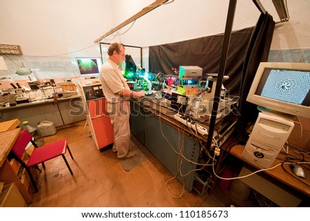 Scientist engaged in research in his lab about movement of microparticles by laser