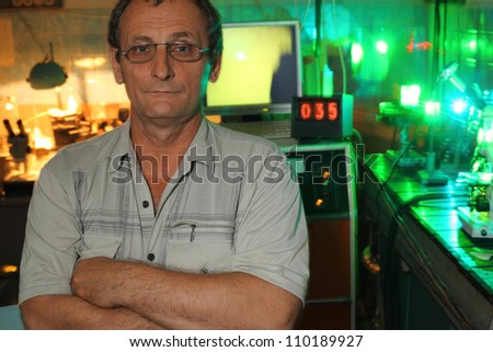 Scientist with glass pose in his lab of movement of microparticles by laser