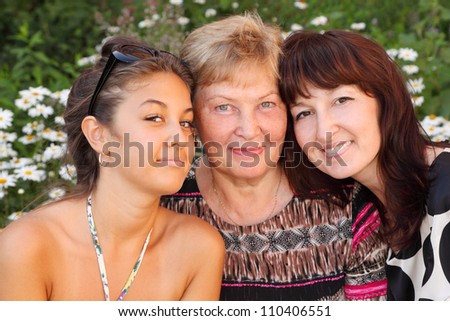 Grandmother, mother, daughter in park, closeup