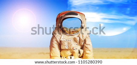 Collage with an astronaut on another planet against background of barren desert and big moon