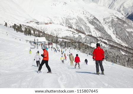 Skiers go down from hill to ski lift
