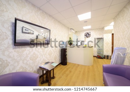 Empty reception and rest room with sofas, tv in medical center