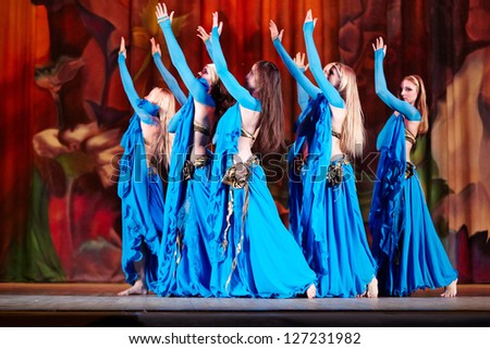 MOSCOW - JAN 28: Dancing collective in blue suits dances on stage of Red October Culture Palace during Bellydance Superiority of Moscow, Jan 28, 2012, Moscow, Russia.