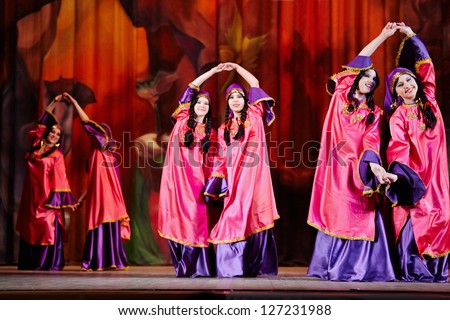 MOSCOW - JAN 28: Teenage dancing collective dressed in oriental dress dances on stage of Red October Culture Palace during Bellydance Superiority of Moscow, Jan 28, 2012, Moscow, Russia.