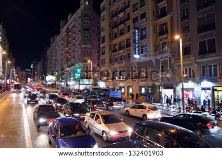MADRID - MARCH 10: Cars and people at Gran Via street at night on March 10, 2012 in Madrid, Spain. Gran Via unofficially considered main street of capital of Spain.
