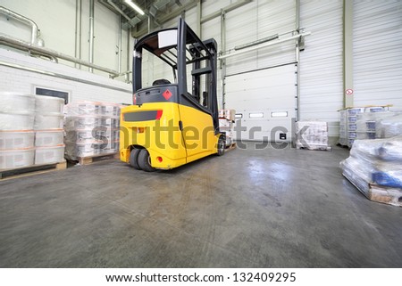 MOSCOW - JUNE 5: Yellow loader machine in warehouse at Caparol factory on June 5, 2012 in Moscow, Russia. Caparol company working at Russian market for 20 years.
