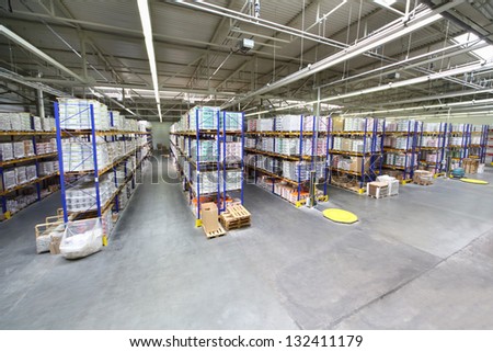 MOSCOW - JUNE 5: Warehouse with rows of shelves at Caparol factory on June 5, 2012 in Moscow, Russia. Caparol company has 10 branches in Russia.