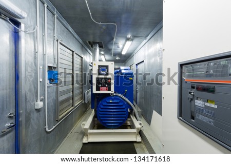 Diesel generator for backup power in room with control panel..