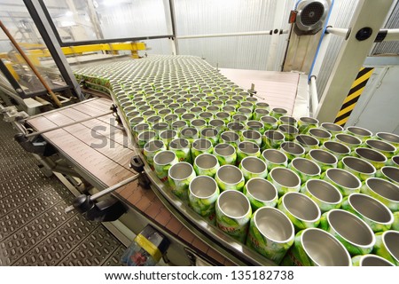 MOSCOW - MAY 16: Many open green cans move on conveyor in Ochakovo factory, on May 16, 2012 in Moscow, Russia. Ochakovo has breweries in several Russian cities - Moscow, Krasnodar, Tyumen, Penza.