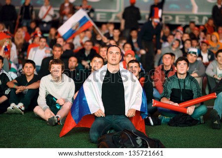 MOSCOW - JUN 8: Russian fans with flags gathered in Fanzone in All-Russian Exhibition Center to support national team on UEFA EURO 2012, on Jun 8, 2012 in Moscow, Russia