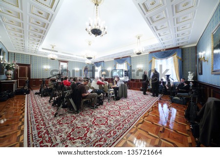 MOSCOW - APRIL 24: Newspersons sit in front of TV on Enlarged meeting of Council in Stuffed hall of guest annexe in Grand Kremlin Palace on April 24, 2012 in Moscow, Russia.