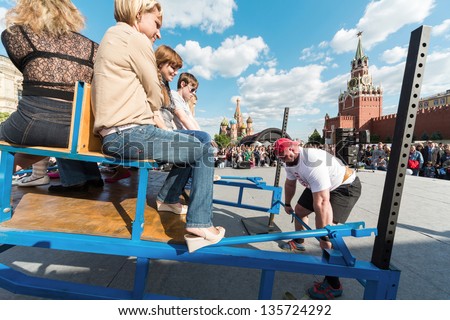 MOSCOW - MAY 26: Strongman is ready to raise a heavy load on VIII Forum Ready for Labor and Defense on May 26, 2012 in Red Square, Moscow, Russia.