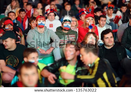 MOSCOW - JUN 8: Russian fans with flags on face gathered in Fanzone in All-Russian Exhibition Center to support national team on UEFA EURO 2012, on Jun 8, 2012 in Moscow, Russia