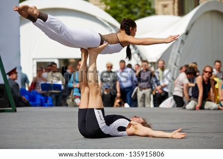 MOSCOW - MAY 27: Performance of yoga couple on Red Square during 8-th sports forum GTO, May 27, 2012, Moscow, Russia. More than 50 teams perform their sports program in forum.