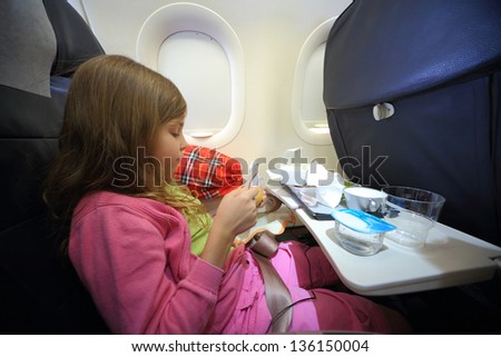 Girl with empty boxes of food for the plane