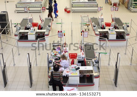 SAMARA - MAY 5: Cashier check products in Auchan superstore, on May 5, 2012 in Samara, Russia. French distribution network Auchan unites more than 1300 shops.