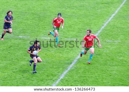 MOSCOW - JUNE 30: Rugby players run at fighting for ball on second stage of European championship on rugby-7 in sports complex Luzhniki, on June 30, 2012 in Moscow, Russia.