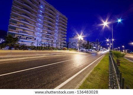 Empty night illuminated road in city