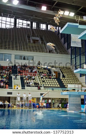 MOSCOW - APR 13: (Serial shots) Female athlete jumps from diving-tower in Pool of SC Olympic on day of third phase of World Series of FINA Diving, April 13, 2012, Moscow, Russia.
