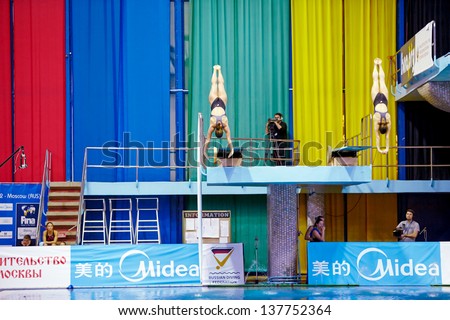 MOSCOW - APR 13:  Female athletes perform syncronized jump from springboard at Pool of SC Olympic on day of third phase of the World Series of FINA Diving, April 13, 2012, Moscow, Russia.