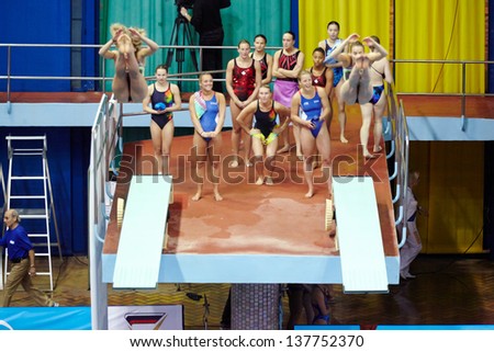 MOSCOW - APR 13:  Female athletes perform syncronized jump in Pool of SC Olympic on day of third phase of the World Series of FINA Diving, April 13, 2012, Moscow, Russia.