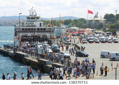 ISTANBUL - JUL 3: Ferry came to the pier and people and car come ashore on July 3, 2012 in Istanbul, Turkey. Ferries is a very common way of transportation in Istanbul.