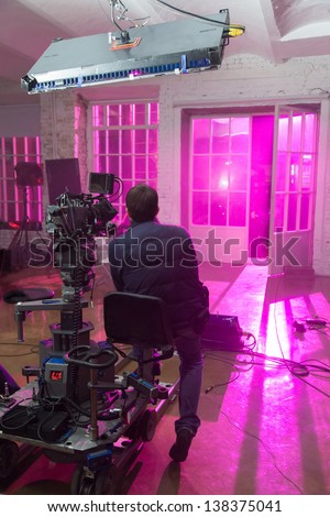 The camera shoots a scene with purple room, filmed in a rented public studio.