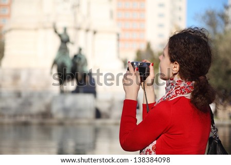 MADRID - MARCH 9: Woman photographs monument to Don Quixote and Sancho Panza, on March 9 2012 in Madrid, Spain. Since 2012 Spain has 52 million visitors, 3% increase over last year.
