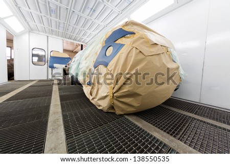 The car wrapped in a paper prepared for painting in the body shop